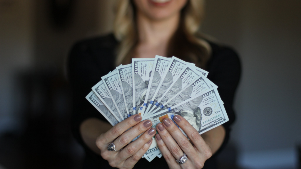 Smiling woman holding money