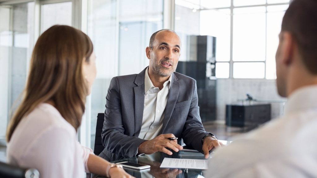 Financial advisors talking to 2 clients